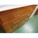 A MID WOOD CHEST OF FIVE DRAWERS WITH FORMICA TOP. *