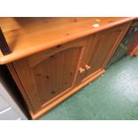 A COMPOSITE PINE TWO DOOR CUPBOARD. *