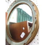 CIRCULAR BEVELLED EDGED WALL MIRROR IN A PAINTED GILT EFFECT FRAME.
