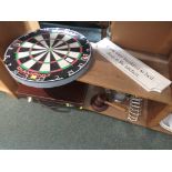 A DART BOARD , LEATHER BRIEF CASE , PEWTER TANKARD AND OTHER ITEMS (TWO SHELVES)