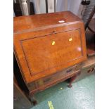 A WALNUT VENEERED SINGLE DRAWER BUREAU ON CABRIOLE LEGS.