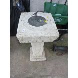 A COMPOSITE STONE TWO PIECE SUN DIAL WITH METAL DIAL TO TOP.