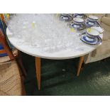 WHITE CIRCULAR KITCHEN TABLE WITH LIGHT WOOD LEGS. *