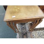 A NEST OF THREE MAHOGANY VENEER OCCASIONAL TABLES. *