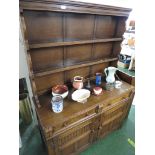 STAINED OAK DRESSER WITH TWO PLATE SHELVES TO TOP AND TWO DRAWERS OVER TWO CUPBOARD DOORS TO BASE.