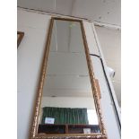 LONG RECTANGULAR WALL MIRROR IN A GOLD EFFECT FRAME.