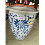A BLUE AND WHITE GLAZED UMBRELLA/STICK STAND WITH FLORAL PATTERN.