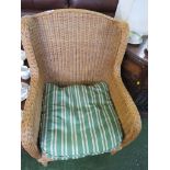 WICKER ARM CHAIR WITH STRIPED LOOSE CUSHION.