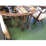 SMALL OAK OVAL GATE LEGGED TABLE WITH BARLEY TWIST SUPPORTS.