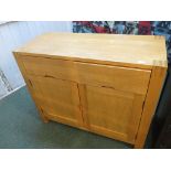 AN ACTONA LIGHTWOOD SIDEBOARD WITH TWO DRAWERS TO TOP AND TWO CUPBOARD DOORS TO BASE (A/F)