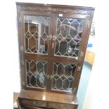 OLD CHARM FURNITURE STAINED OAK GLAZED BOOK CASE WITH LEADED GLAZED DOORS TO TOP AND TWO CUPBOARD