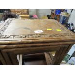NEST OF THREE SMALL HARD WOOD OCCASIONAL TABLES WITH FOLIATE CARVING TO TOPS. (AF)