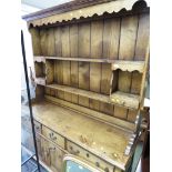 A REPRODUCTION OAK FARMHOUSE DRESSER WITH OPEN SHELVES AND TWO SMALL DRAWERS TO TOP AND THREE