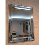 A RECTANGULAR WALL MIRROR WITH MIRRORED GLASS FRAME.