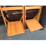 PAIR OF LIGHT WOOD FOLDING CHAIRS. *