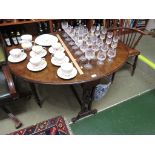 19TH CENTURY WALNUT VENEERED GATE LEGGED SUTHERLAND TABLE ON BRASS CASTERS.