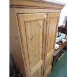 HONEY PINE TWO DOOR WARDROBE WITH SINGLE DRAWER TO BASE.