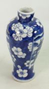 Chinese blue and white vase: Prunus background, panels with oriental scenes. 19cm high.