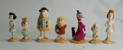 A collection of Beswick Flintstones figures: Fred and Wilma, Pebbles Flintstone, Barney and Betty,