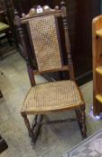 Late Victorian child's oak rocking chair: with cane work to the seating and back. Height 94cm