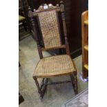 Late Victorian child's oak rocking chair: with cane work to the seating and back. Height 94cm