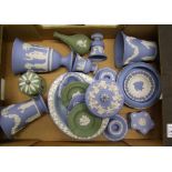 A collection of Wedgwood Jasperware items: in blue and green, vases, candle holders, lidded boxes