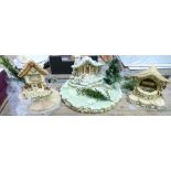A collection of Pendelfin stands : to include wishing well, cobble cottage, Christmas Island,