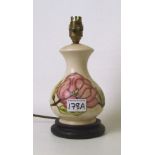 A Moorcroft Magnolia pattern on cream ground lamp base: overall height 25cm.