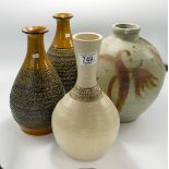 A collection of studio pottery to include: stoneware vase signed tollow and three Purbac pottery