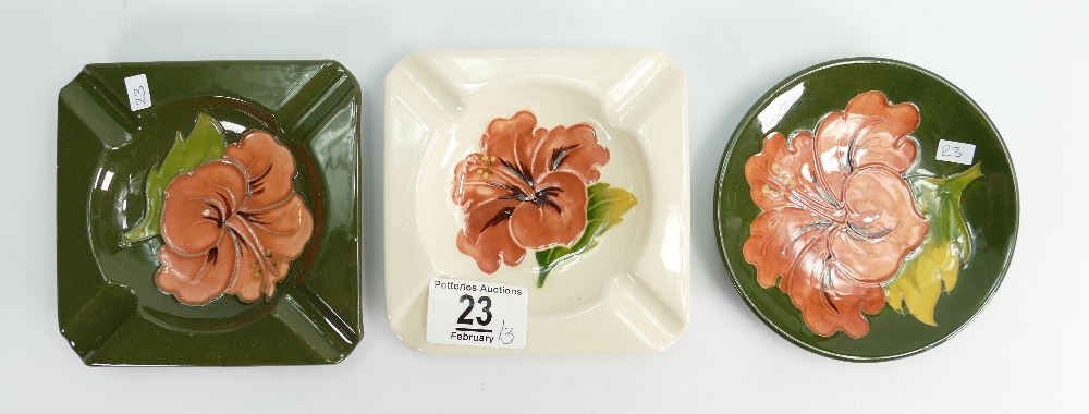 Moorcroft Hibiscus coaster: (boxed) together with two Hibiscus ashtrays.