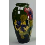 Moorcroft large Hibiscus vase: On a green to blue ground. Walter Moorcroft in green to base.