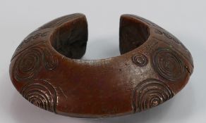Tribal Art - an African gilt patinated bronze bangle or torc, possibly Benin,