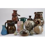 A collection of studio and Slipware pottery items to include: Vases, loving cups, puzzle jugs etc.