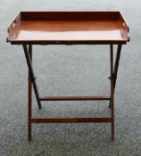 Mahogany Butler tray: On collapsible stand, height 86cm, length 78cm and depth 48cm.