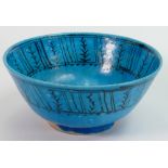 Persian pottery bowl decorated with primitive fish design: In a turquoise glaze, 18.5cm diameter.