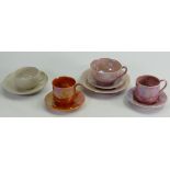 A collection of various Ruskin cups and saucers: Decorated in pink, orange & grey lustres,