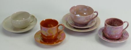 A collection of various Ruskin cups and saucers: Decorated in pink, orange & grey lustres,