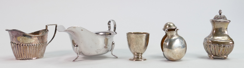 A collection of silver items: Including salt pot, 2 x sauce boats, egg cup and small flask, 265g.