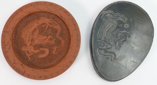 A Chinese embossed Terracotta dragon plate and a slate box & cover: Diameter of plate 18cm.