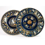 Two Gebruder Schutz Majolica chargers: Both decorated with cupids makers mark and 'Made in Austria'