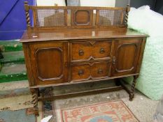 Oak early 20th Century sideboard: with inset bergere handles