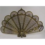 A brass fan shaped fire guard.