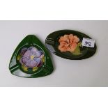 Two Moorcroft ashtrays: in the Hibiscus and Clematis designs