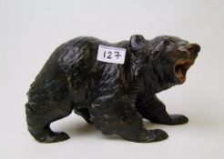 A large black forest carved model of a wooden bear: