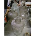 A collection of 7 glass demi johns: