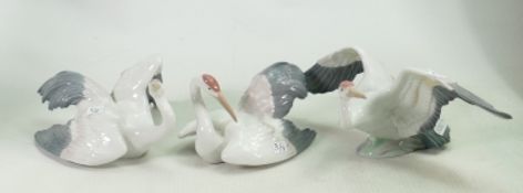 Three Lladro small crane figures Fluttering, nesting and landing cranes - model numbers 1598,1599, &