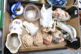 A mixed collection of items to include: damaged continental figures, sea shells. decorative boot etc