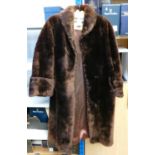 Fur coat size 12 14: Knee length brown.