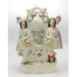 Large Staffordshire Figure of Flower Sellers Astride a Clock: height 32cm