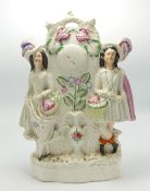 Large Staffordshire Figure of Flower Sellers Astride a Clock: height 32cm